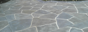 Close-up of a stamped flagstone-pattern decorative concrete patio surface
