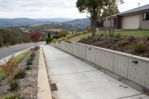 Freshly completed concrete retaining wall with a clean finish