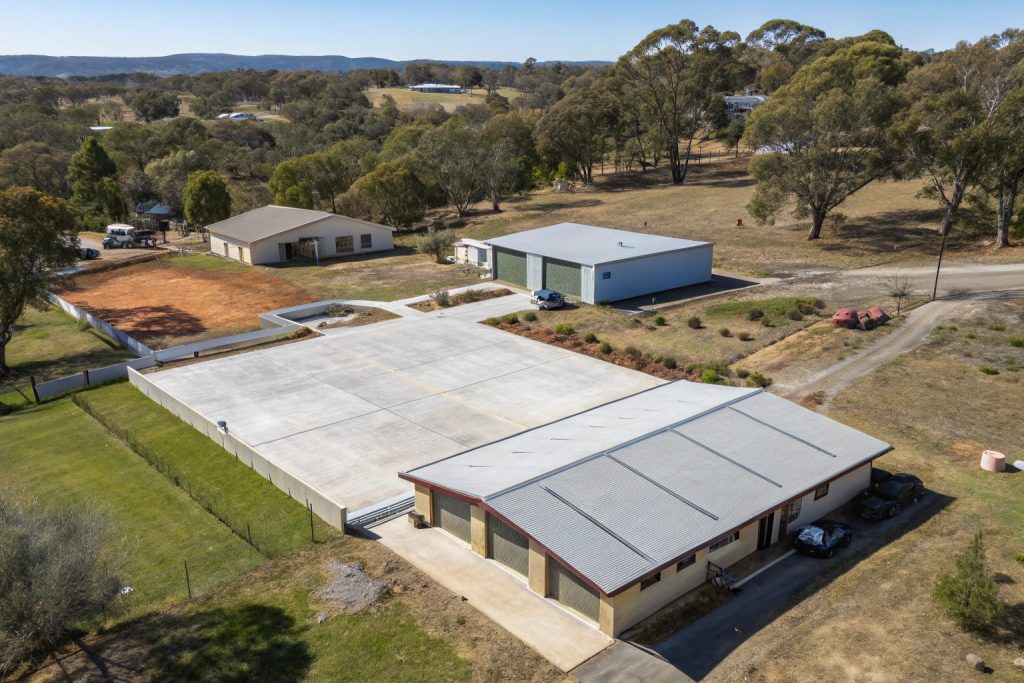 Aerial view of several concrete shed slabs and foundations under construction