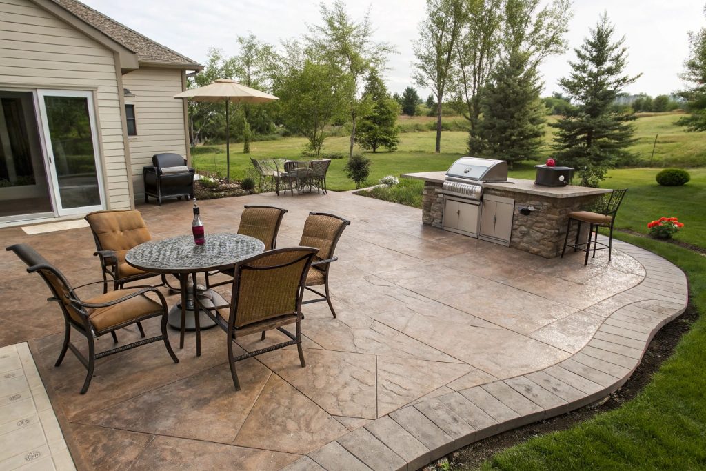 Attractive stamped concrete patio with outdoor furniture.