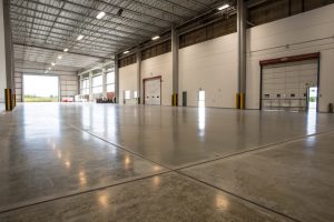 Smooth concrete floor finish inside a large warehouse
