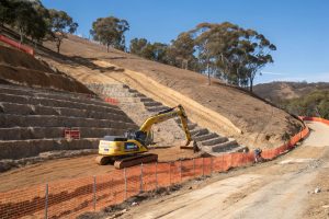 Excavation site on a sloping hillside prepared for multi-unit development